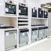 line of up stainless steel appliances in a store - Appliance Solutions reconditioned appliances
