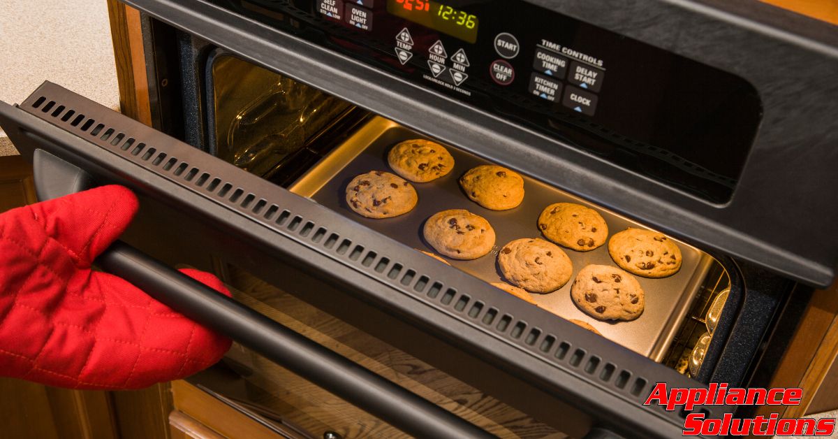 inside of an oven with cookies on a baking sheet - Appliance Solutions oven repair