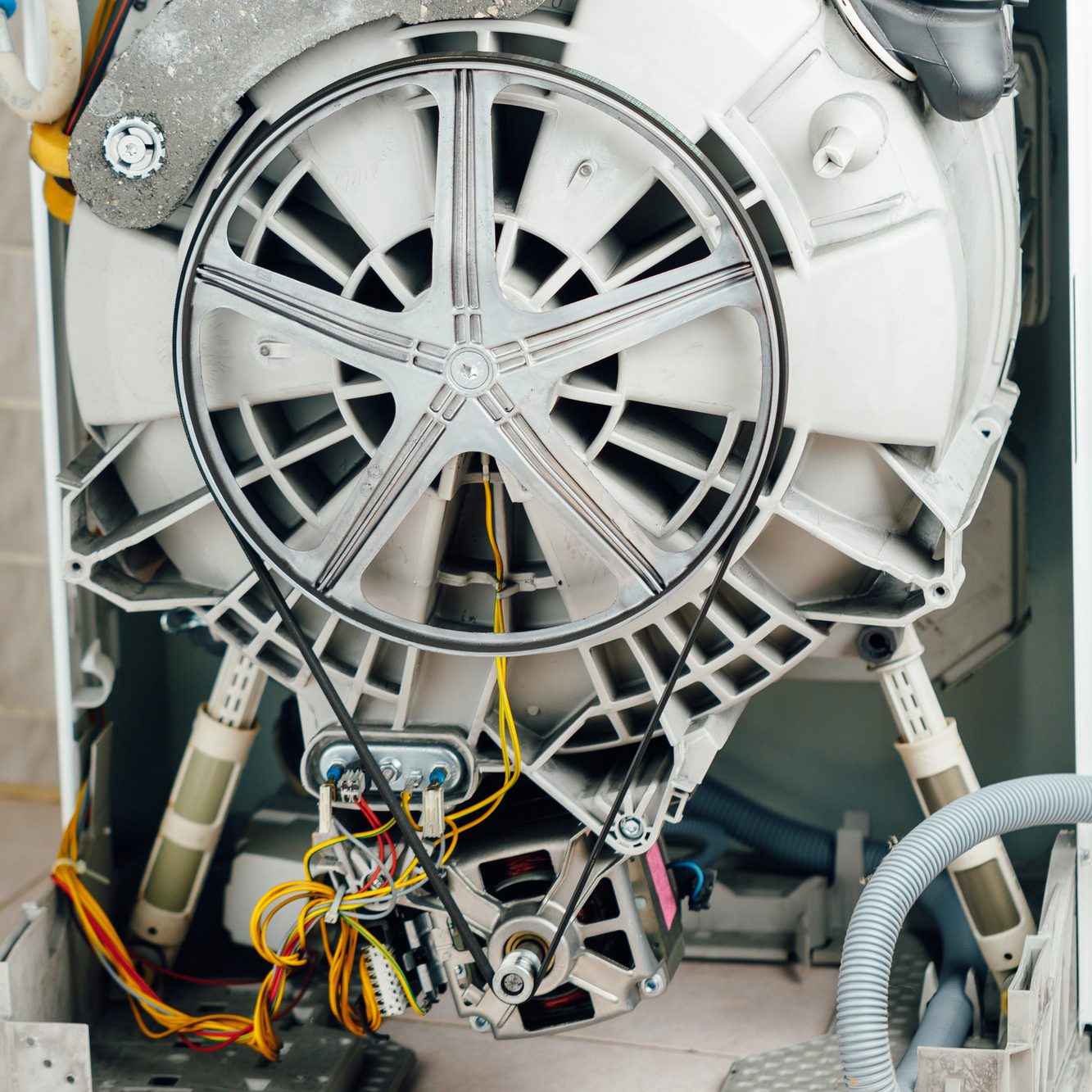bottom of a home appliance with wires and plastic pieces - Appliance Solutions appliance parts