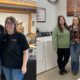employees standing together in a warehouse setting - Appliance Solutions home appliances near me